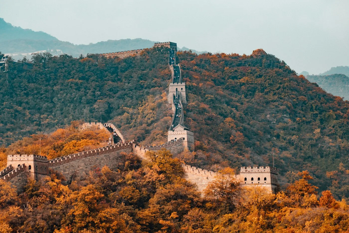 The Great Wall winding through autumn-colored mountains near Beijing